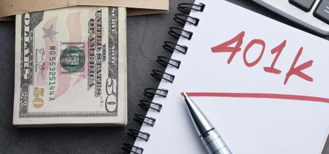 401k financial planning setup with money and pen